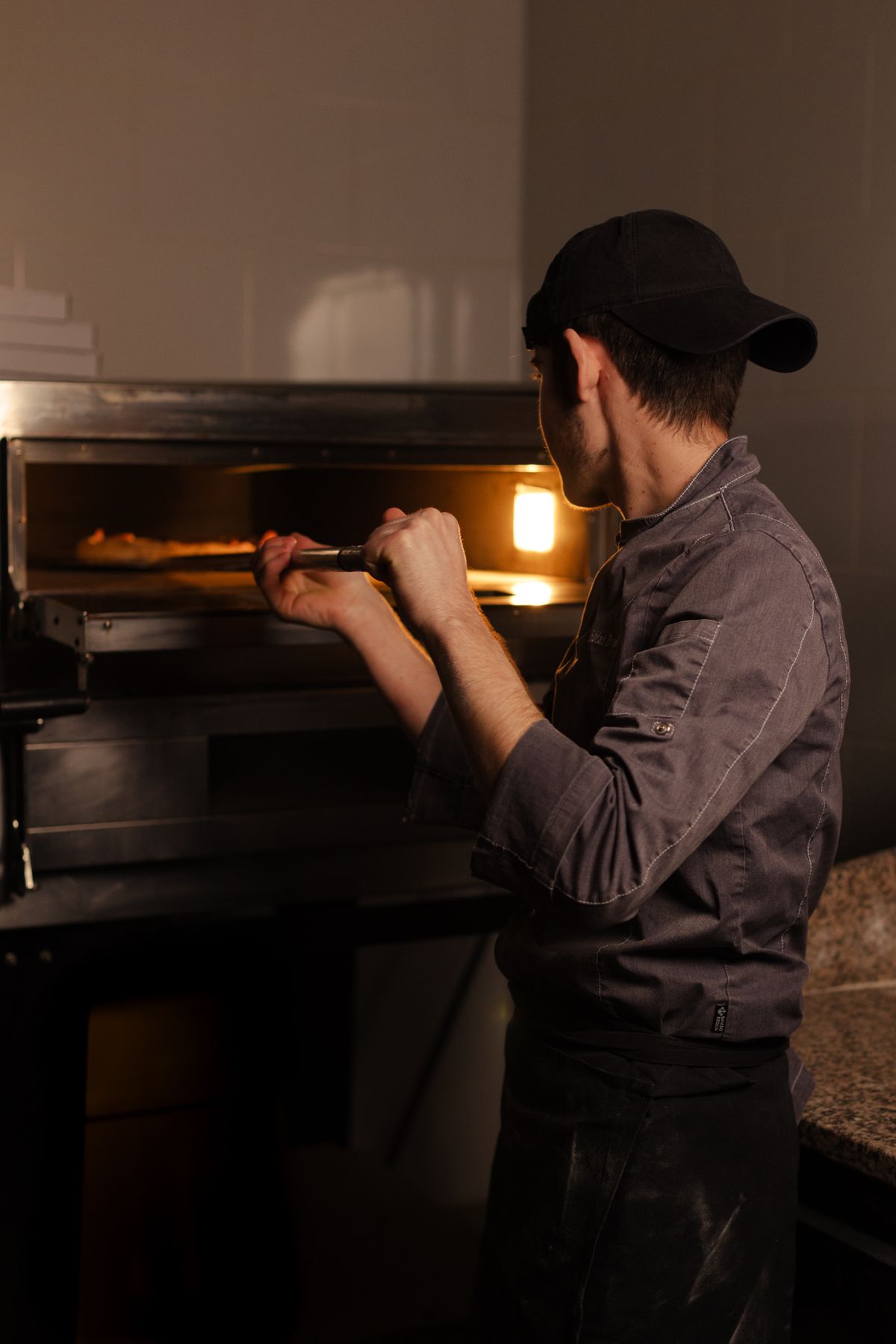 Pizza going into the oven